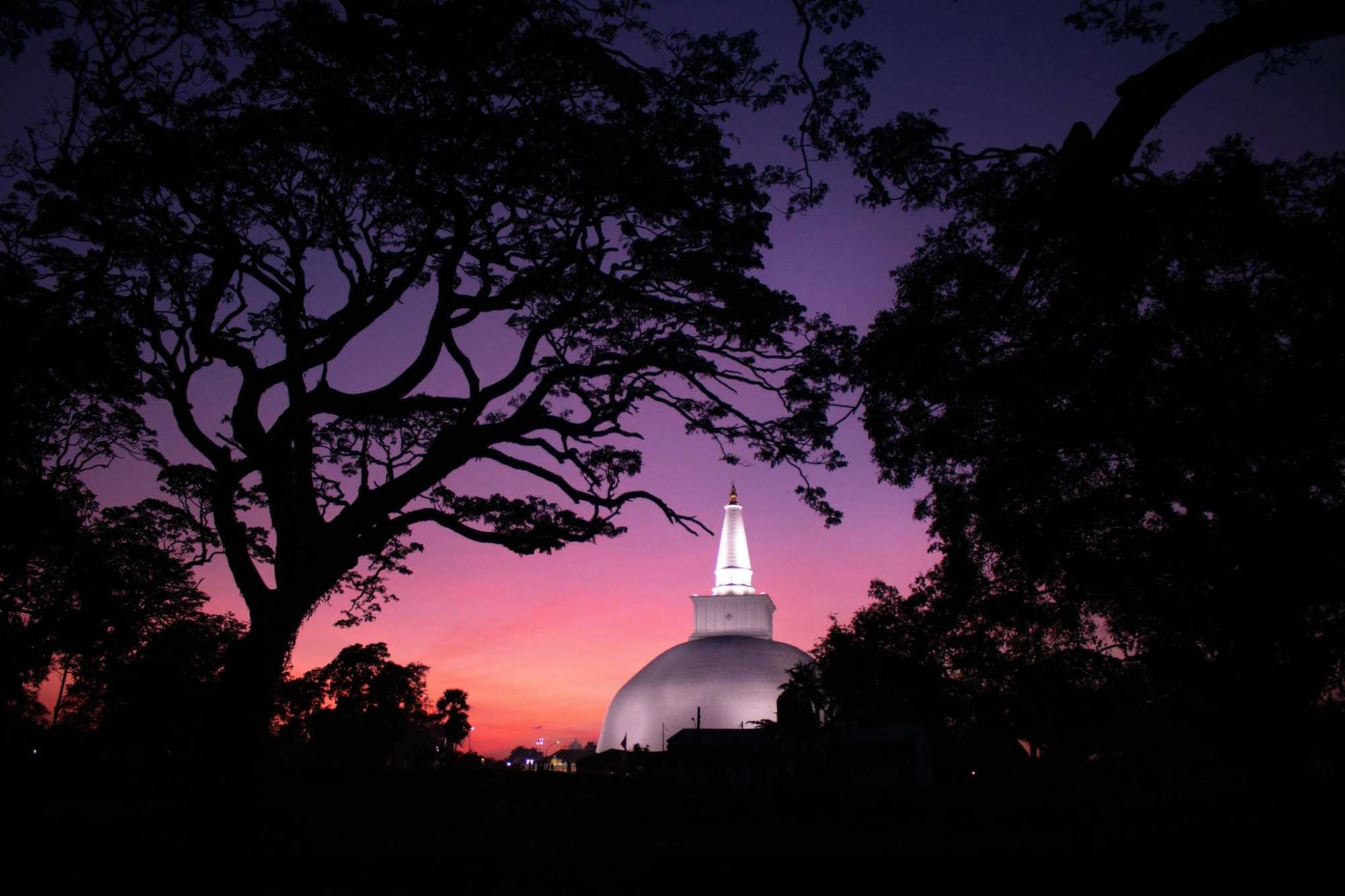 First light striking a white dagoba in the ancient city of Anuradhapura